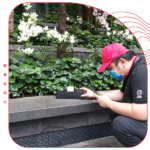 ORIGIN Exterminators technician conducting pest inspection in outdoor commercial area