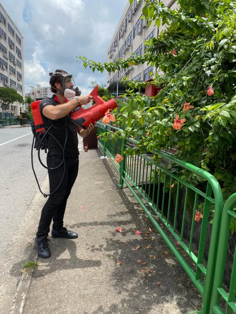 ORIGIN technician performing outdoor mosquito fogging treatment in residential area
